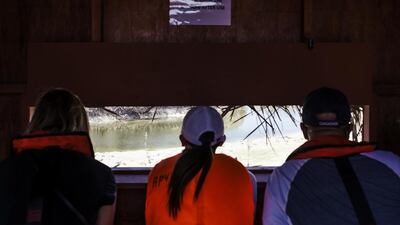 From left: Laura Koot, The National’s Managing Editor, reader Janice Liu, and Arif Lalani, Canada's ambassador to the UAE, look out from the bird watching hut.