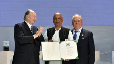 Architect Saif Ul Haque, centre, is presented an Aga Khan Award for Architecture 2019 certificate for the Arcadia Education Project.