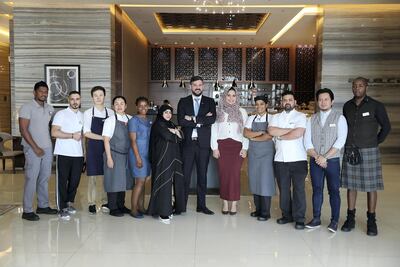 David Allan, centre, general manager of The Radisson Blu hotel in Business Bay, Dubai, with his staff. Pawan Singh / The National
