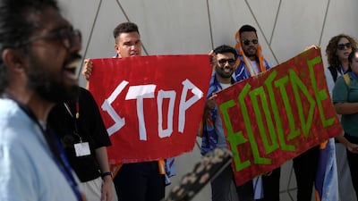 Demonstrators at the Cop28 UN climate summit in Dubai with their message to 'stop ecocide'. AP