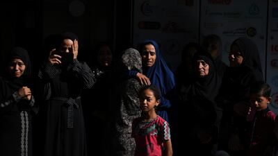Mourners gather at Al Awda Hospital in Nuseirat camp to attend the funeral of Palestinians killed in an Israeli air strike on the Gaza Strip. AP