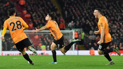 Wolves midfielder Pedro Neto (C) celebrates with team-mates after putting the ball in the Liverpool net, a goal that was subsequently ruled out by VAR. AFP