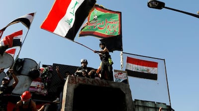 Iraqi demonstrators take part in an ongoing anti-government protests, in Baghdad. Reuters