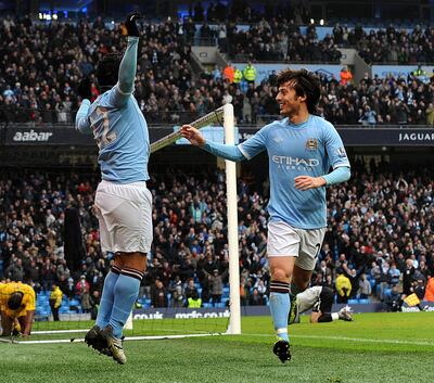 Manchester City's Argentinian forward Carlos Tevez celebrates with David Silva. AFP