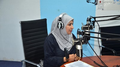 Afrah Mohammed Juma’a Khan talking on the radio. Courtesy Saeed Al Batati