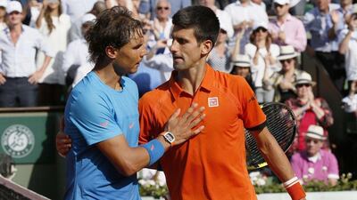 Spain's Rafael Nadal, left, shakes hands with Serbia's Novak Djokovic at the end of their men's quarter-final match of the Roland Garros 2015 French Tennis Open in Paris on June 3, 2015. AFP PHOTO / PATRICK KOVARIK