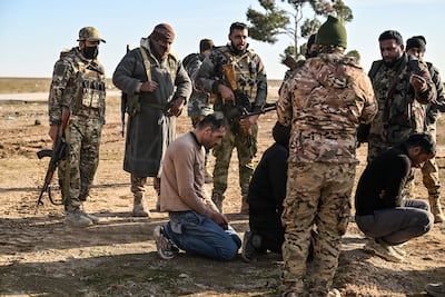 Three SDF members are detained by the Syrian military during its push into SDF-held territory. Getty Images