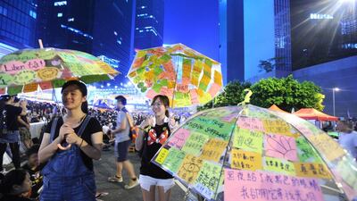 Pro-democracy protesters put up their umbrellas near the government headquarters in Hong Kong on October 2, 2014. On July 22, 2016, three student leaders who were at the forefront of what has now been termed the “Umbrella Movement”, were convicted of participating in and inciting others to join the protests. The Yomiuri Shimbun via AP Images
