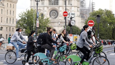 Bikers wearing protective masks ride past Notre Dame Cathedral, as France reinforces mask-wearing as part of efforts to curb a resurgence of Covid-19 across the country, in Paris, France August 28, 2020. Reuters