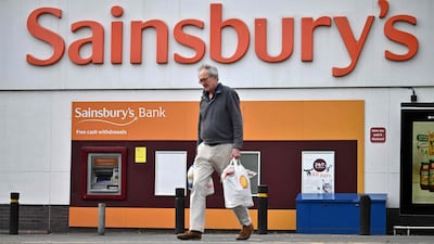 A shopper walks away from a Sainsbury's supermarket store in Tonbridge, south-east of London on April 28, 2022. - Sainsbury's showed pre-tax profits for the 12 months to March 5, 2022 rose to £854 million as the supermarket was advantaged by the pandemic. (Photo by Ben Stansall / AFP)
