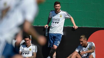 From left: Angel Di Maria, Lionel Messi and Roberto Pereyra take time out from training. AFP