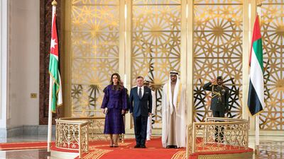 Sheikh Mohammed bin Zayed, Crown Prince of Abu Dhabi and Deputy Supreme Commander of the UAE Armed Forces (R) and King Abdullah II, King of Jordan (C), stand for the national anthem during a reception at the Presidential Airport. They are seen with Queen Rania of Jordan (L). Hamad Al Kaabi / Crown Prince Court - Abu Dhabi
