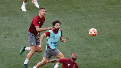 Liverpool forward Mohamed Salah, centre, and Georginio Wijnaldum, right, vie for the ball. AP Photo