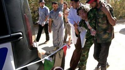 A Libyan rebel fighter and volunteers help a fighter injured during a battle with forces loyal to Muammar Qaddafi near Misurata yesterday. Zohra Bensemra / Reuters