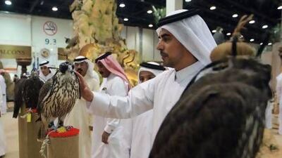 Visitors to last year's Adihex examine falcons on sale. This year's event, which takes place at Abu Dhabi National Exhibition Centre next week, promises to be a showcase for Emirati traditions. Ravindranath K / The National