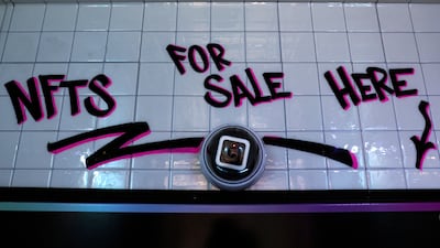A sign saying 'NFT for sale here' in a small storefront that hosts digital art-collecting platform Neon's first in-person non-fungible token vending machine in New York City. Reuters