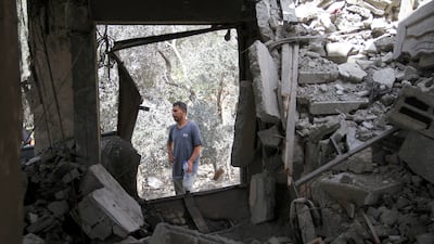 A Palestinian man stands at the site of an Israeli strike on a house in Beit Lahia in the northern Gaza Strip. Reuters