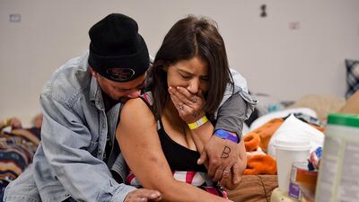 Joseph Grado and his wife, Susan Grado, hug one another while staying at a shelter for fire victims at East Avenue Church in Chico. AP Photo
