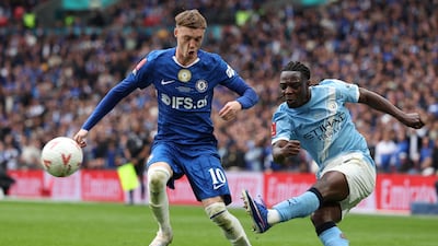 Manchester City's Jeremy Doku battles with Chelsea's Cole Palmer. AFP