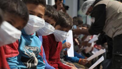 Displaced Syrian children and their parents attend a workshop organised by medical volunteers affiliated with a Turkish-registered Syrian relief organisation at a camp near the Syrian town of Atme close to the border with Turkey in Idlib province. AFP
