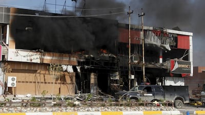 Smoke rises from burning shops in Tikrit on April 2, 2015, after the Iraqi army and allied militias claimed victory over ISIL fighters in the city. Ahmed Saad / Reuters