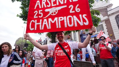 Arsenal fans assemble along Holloway Road during the victory parade. PA