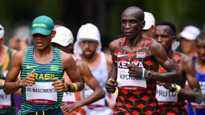 Daniel Do Nascimento of Brazil, left, and Eliud Kipchoge of Kenya during the men's marathon at Sapporo Odori Park.