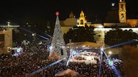 The lighting of the Christmas tree on Manger Square, with the Church of the Nativity in the background, in Bethlehem. EPA