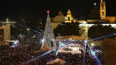 The lighting of the Christmas tree on Manger Square, with the Church of the Nativity in the background, in Bethlehem. EPA