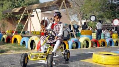 A student from Al Athbaa Primary School in Al Khawanej, Dubai enjoying the outdoor classroom made from 500 used tyres donated by Dubai Municipality. Mike Young / The National