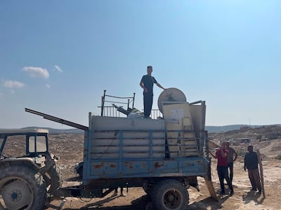 Palestinians in the South Hebron Hills fleeing settler violence. The flags of donor countries can be seen on the infrastructure. Thomas Helm/ The National