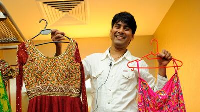 Sayed Faisal, wardrobe manager, The Merchants of Bollywood, holds up two costumes worn by lead dancer Carol Furtado.