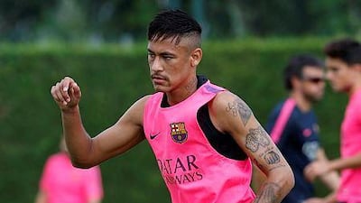 Barcelona's Neymar stretches during a training session at the Ciutat Esportiva Joan Gamper in Sant Joan Despi, near Barcelona, August 17, 2014. FC Barcelona will take part in the Joan Gamper Trophy to play against Mexican club Leon FC on Monday. REUTERS/Gustau Nacarino