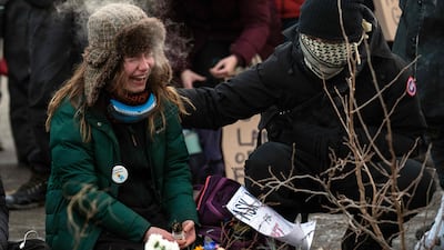 A woman cries at a makeshift memorial in the area where Mr Pretti, 37, was shot dead. AFP