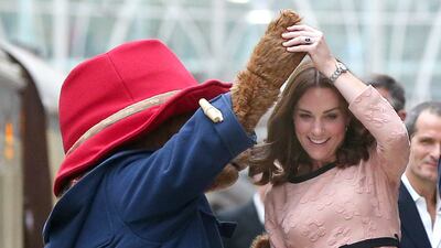 Catherine dances with Paddington Bear as she meets the cast and crew of the film Paddington 2 in London in October 2017
