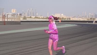 A participant of the Colour Run races to the finish line at the Autodrome. Clint McLean for The National