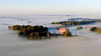 An areal shows the Egeskov castle under morning fog, on the island of Funen, Denmark. AFP