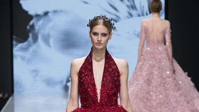 A ballgown in crimson with undulating hem and billowing skirt, encrusted with crystal flowers. Courtesy Michael Cinco and Couturissimo