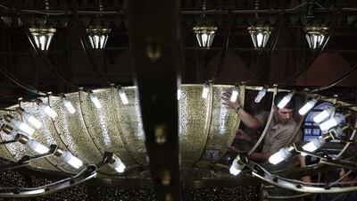 Workers fix parts of the chandelier at the under construction Farooq Mosque in Al Safa area in Dubai.