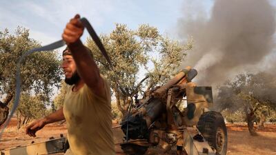 A member of Syria's opposition National Liberation Front fires a 155mm gun towards positions of Russian and regime forces on October 28, 2020, in retaliation to a reported Russian air strike on a training camp 2 days ago, that killed dozens of rebel fighters, in the northwestern Idlib province. / AFP / OMAR HAJ KADOUR