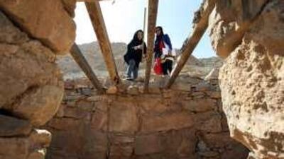Students from Zayed University in Dubai take measurements of an abandoned stone house during a visit to an old tribal mountain village in Ras Al Khaimah.