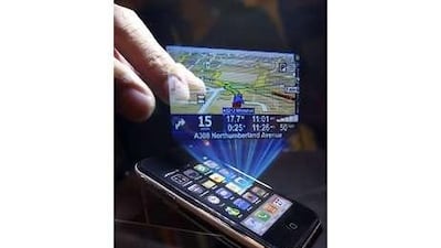 A holograph is projected above a mobile phone by a 3D projecter (not pictured) at the ongoing Computex 2010 computer fair in Taipei. Mobile phones are evolving into an all-in-one device. Pichi Chuang / Reuters