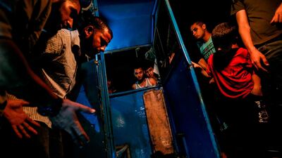 Palestinians look at the destroyed booth of a police checkpoint after an explosion in Gaza City.AFP