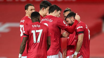 Manchester United's Harry Maguire congratulates Bruno Fernandes after he scores from the penalty spot at the second attempt against West Bromwich Albion. EPA