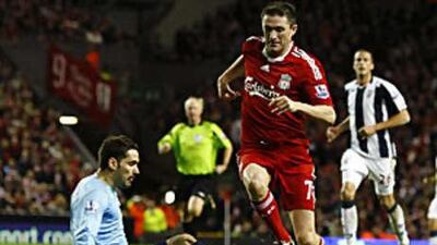 Robbie Keane rounds the West Bromwich Albion goalkeeper Scott Carson to score his second goal in Liverpool's win.
