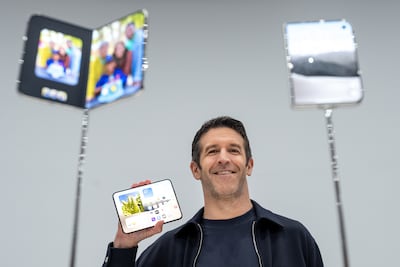 John Ternus, chief executive of Apple Inc, holds the iPhone Duo smartphone at the unveiling event in Cupertino, California. Bloomberg