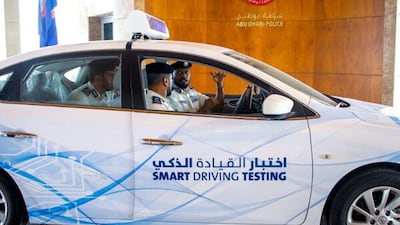 Police officers try out an automated driving test in Abu Dhabi earlier this year. Courtesy Wam
