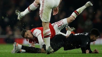Arsenal's Lucas Torreira, top, clashes with Manchester United's Jesse Lindgard. AP