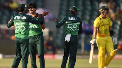 Pakistan's Mohammad Wasim celebrates with teammate Iftikhar Ahmed and captain Babar Azam after taking the wicket of Australia's Ben McDermott. AFP