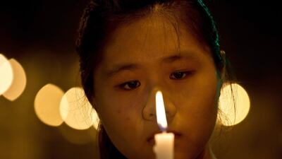 A Malaysian mourner holds a candle during a vigil for missing Malaysia Airlines passengers at the Independence Square in Kuala Lumpur. Manan Vatsyayana / AFP Photo MANAN VATSYAYANA March 10